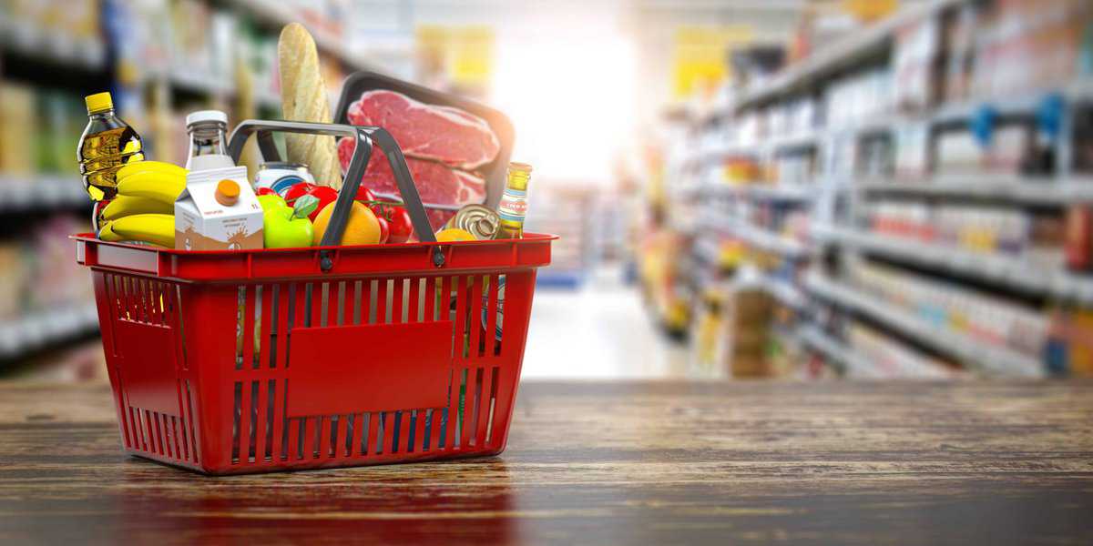 A grocery store basket filled with groceries.